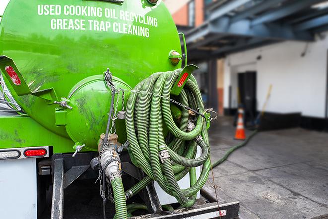 heavy-duty vacuum truck pumping out a grease trap in Atlantic Beach